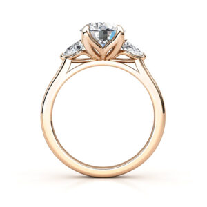 three stone round and pear shaped diamonds rose gold