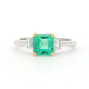 emerald radiant cut ring with yellow gold detail