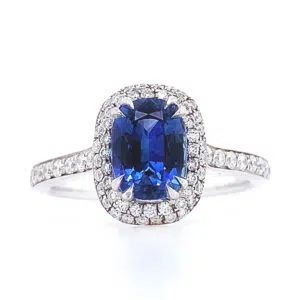 oval blue sapphire halo ring with side diamonds