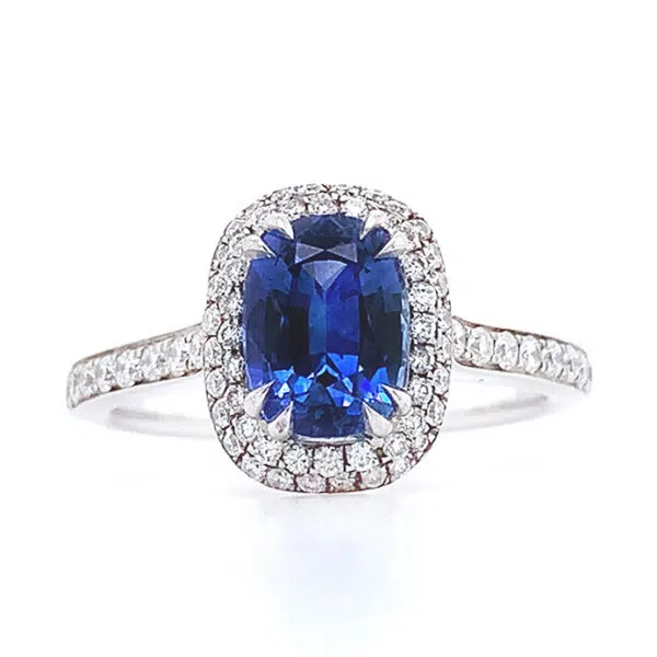 oval blue sapphire halo ring with side diamonds