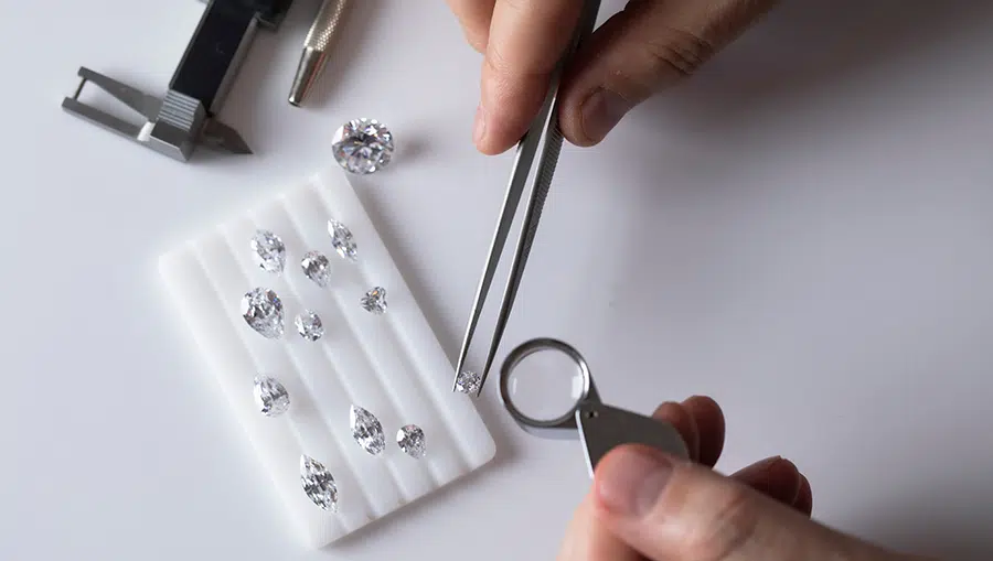 Workplace,Of,Jewellery,Buyer.,Top,View,Of,Hands,With,Tools