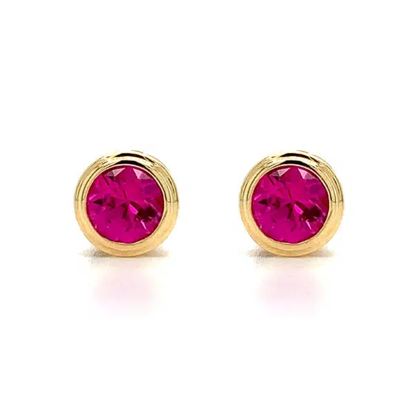 ruby bezel set stud earrings yellow gold