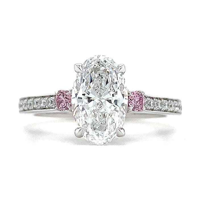 oval diamond engagement ring with pink diamond side stones